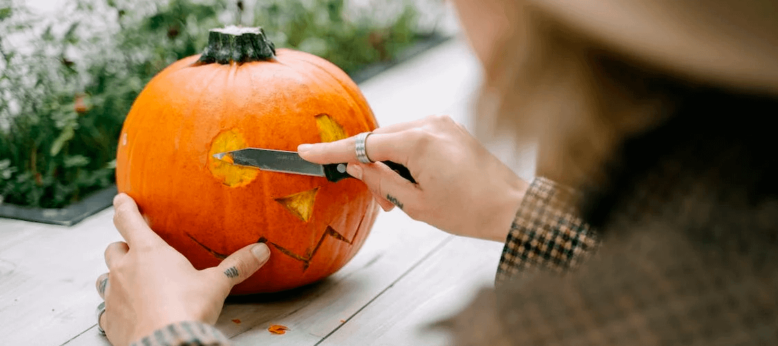 Person carving a pumpkin