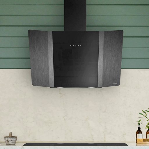 A modern style chimney hood above a flat hob and in front of green slats.