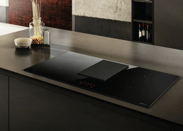An Elica NikolaTesla Prime air venting induction hob in a dark grey , contemporary style kitchen.