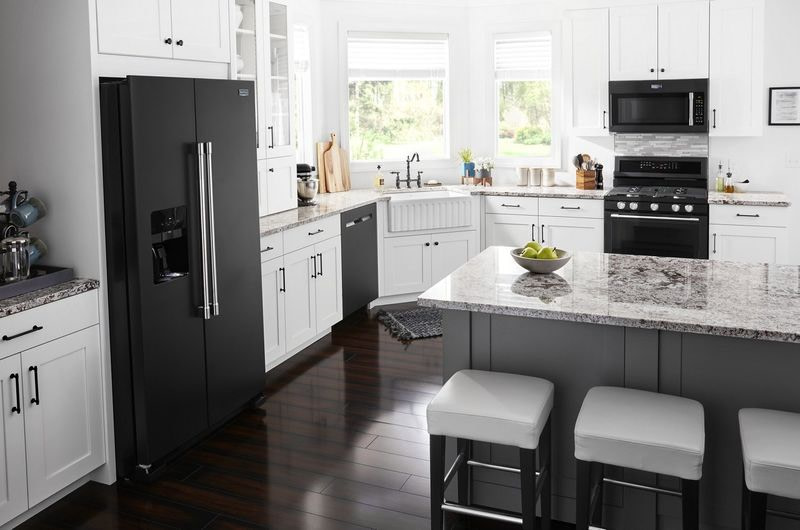 black steel appliances with white cupboards