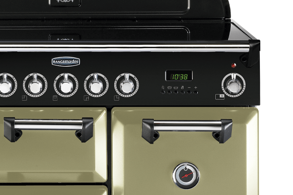 A zoomed in picture of a olive green Rangemaster range cooker, with an induction cooker top.