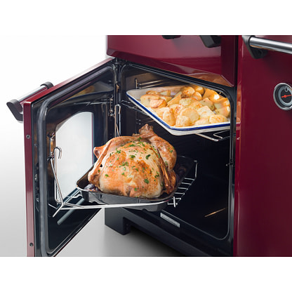 Rangemaster range cooker with door open showing roast potatoes and chicken
