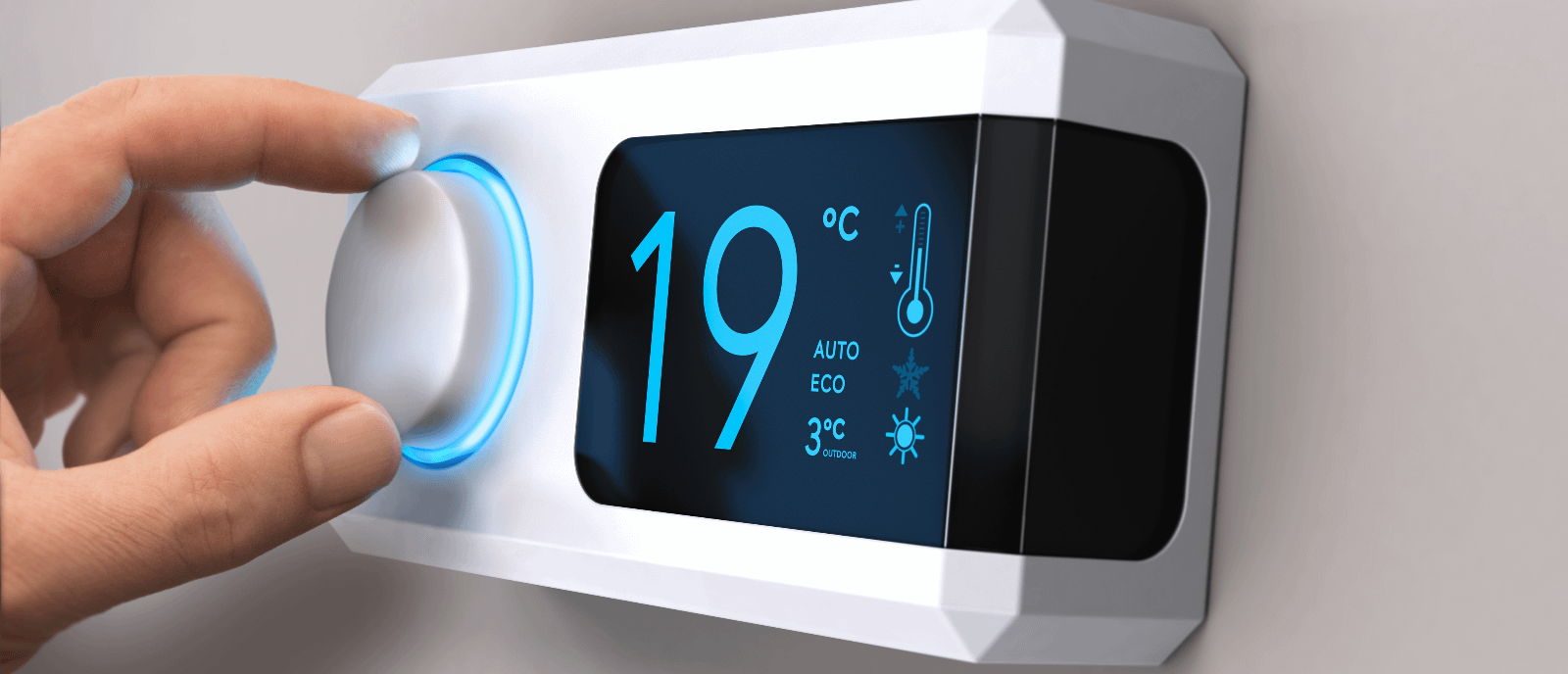 Person turning on thermostat set to 19 degrees Celsius