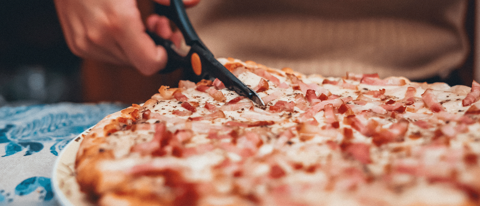 Cutting a pizza with scissors.