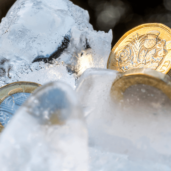 Pound coins frozen in ice