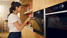 Woman closing a Slide & Hide oven