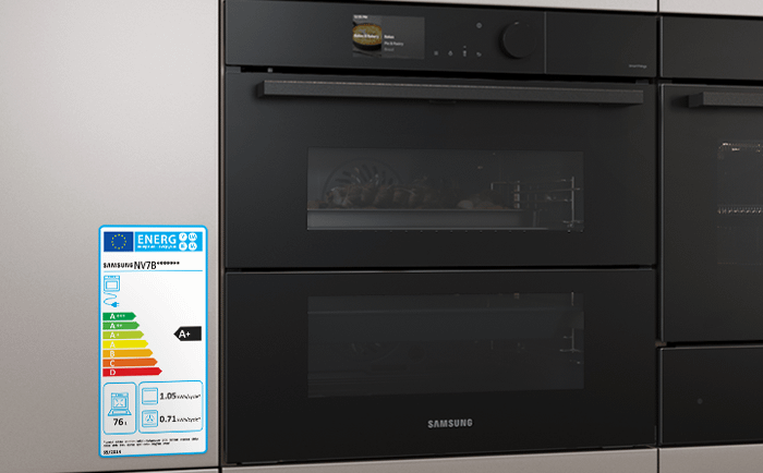 Two black Samsung built-in ovens side by side with an A+ energy rated label stuck onto the cabinet next to them