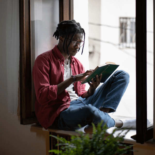 Man reading by an open window