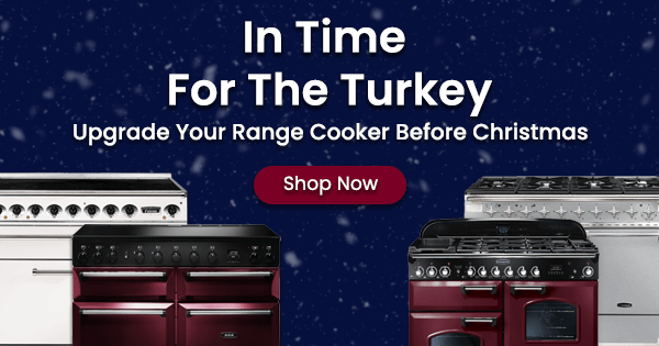 A snowy scene featuring various range cookers in cream, stainless steel and cranberry. The text says "In Time For The Turkey - Upgrade Your Range Cooker Before Christmas"