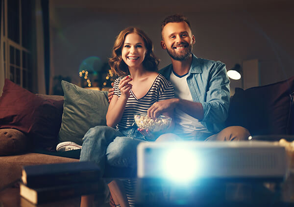 Couple watching a movie on a home projector