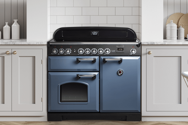 A stone blue classic deluxe induction range cooker in a kitchen with white cabinetry 