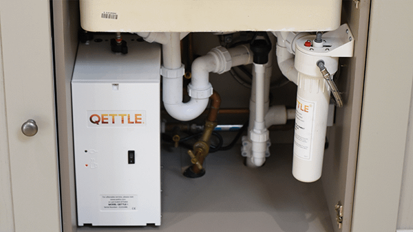 The QETTLE tank under a countertop.
