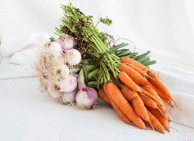 Fresh carrots and onions  bundles together