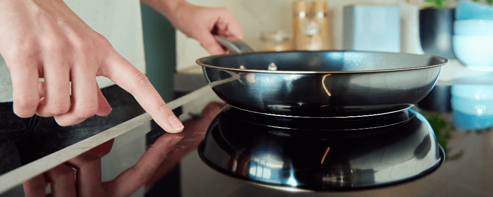 Close up of someone cooking on an electric hob