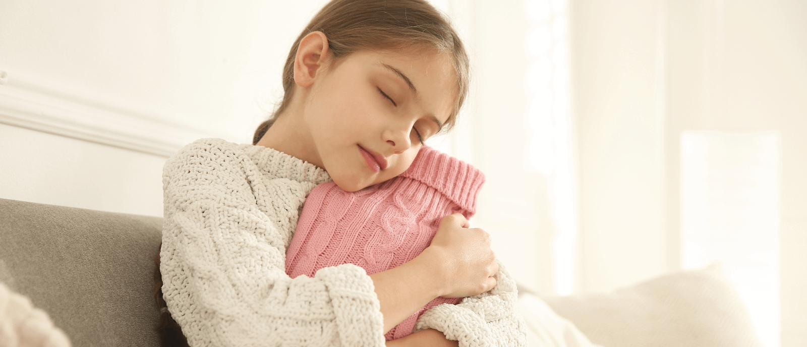 Little girl hugging a hot water bottle