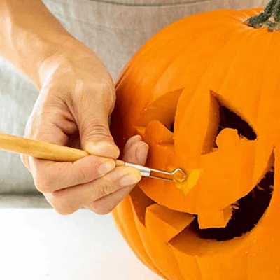 Using a loop tool to carve a pumpkin