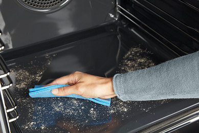 Wiping away ash after a pyrolyric self clean in an oven