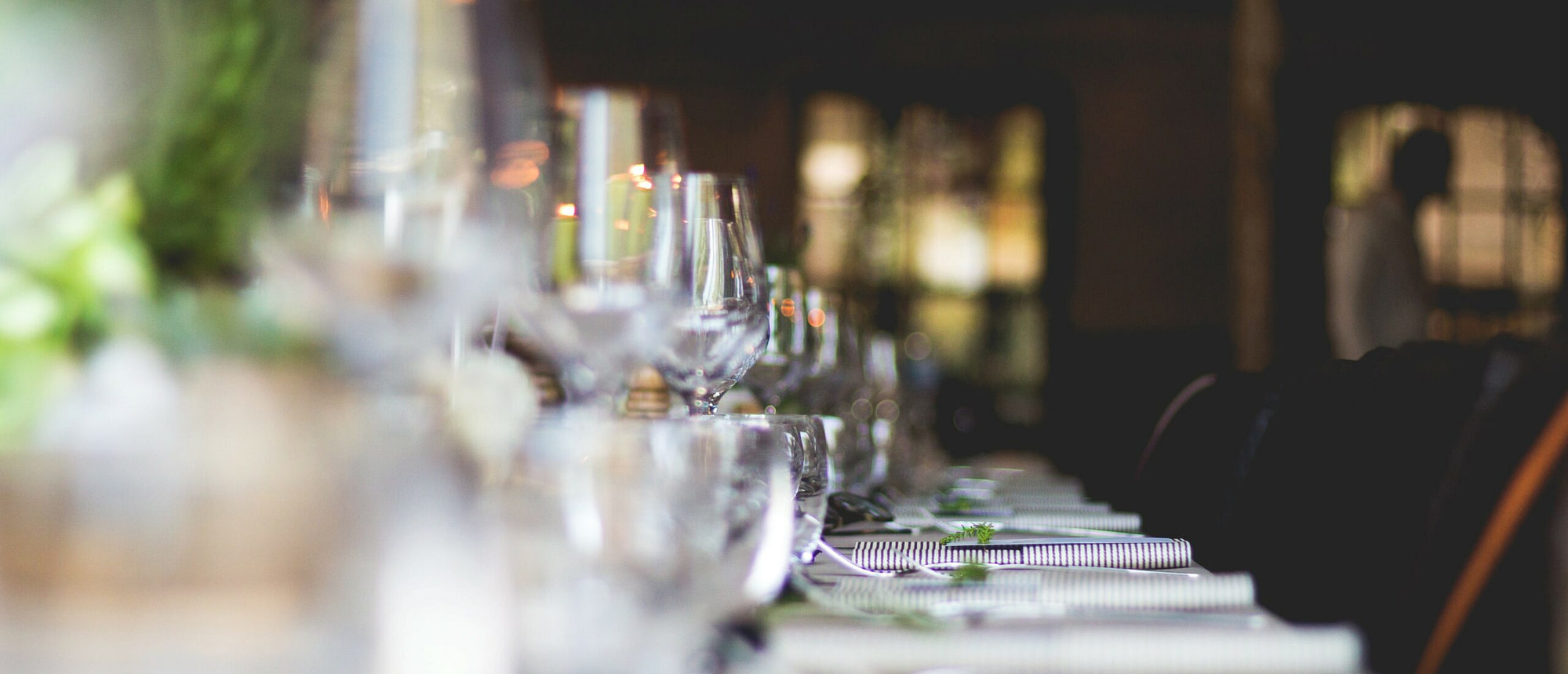 A dinner party with a table set of glasses