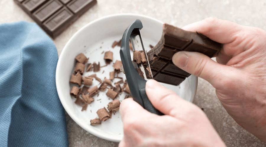 Using a peeler to peel chocolate