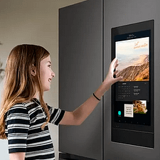 Young girl using Samsung Family Hub fridge screen