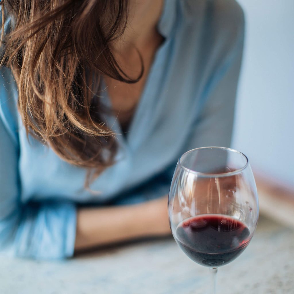 Lady enjoying a glass of red wine