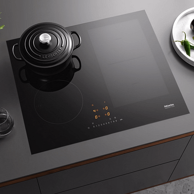 Miele KM7464FL 62cm 4 Zone PowerFlex Induction Hob installed in kitchen counter with black pot on top,