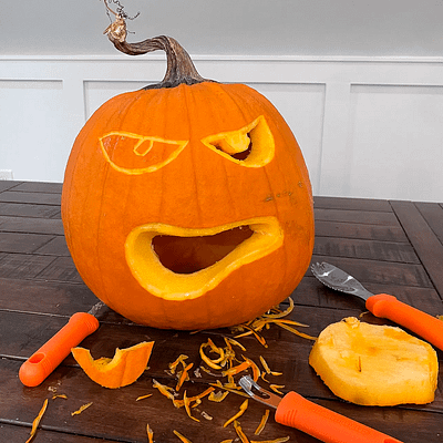 Carving a pumpkin with pumpkin carving tools