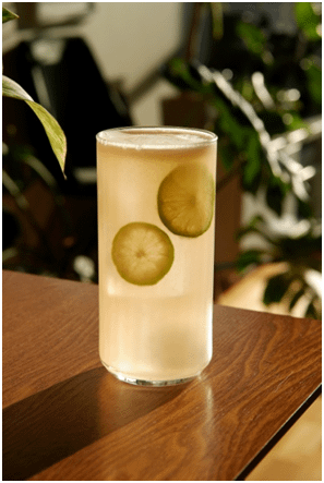 An iced Paloma cocktail with slices of lime in it.