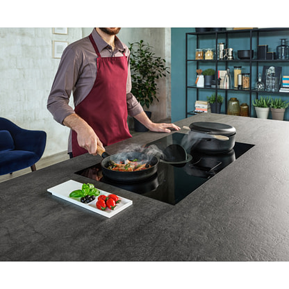 Man cooking on air venting induction hob