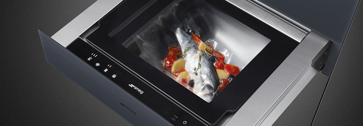 Fish and vegetables being vacuum sealed in a Smeg vacuum drawer