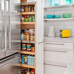 Narrow pull-out storage rack in white kitchen.