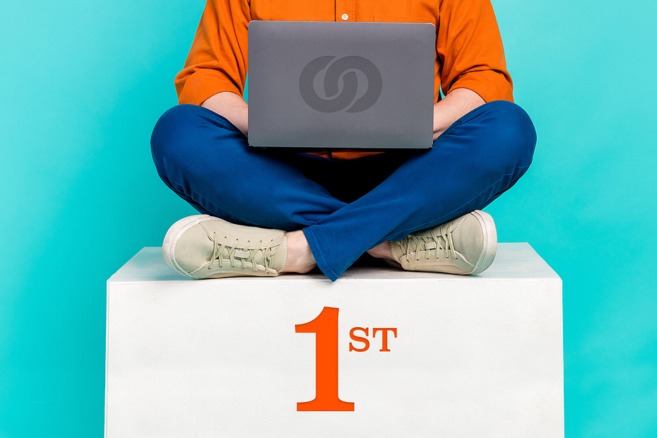 Person using a laptop sat on a first place podium