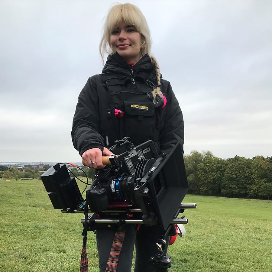 Camera assistant Bianka wearing our LED Chest Rig whilst holding a camera on set