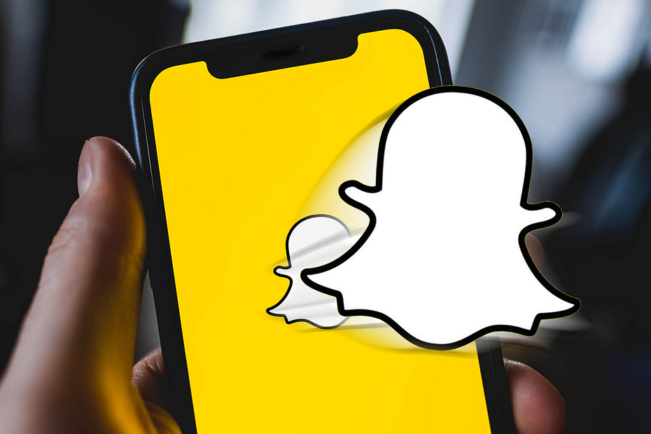 Snapchat logo jumping out of a mobile phone screen