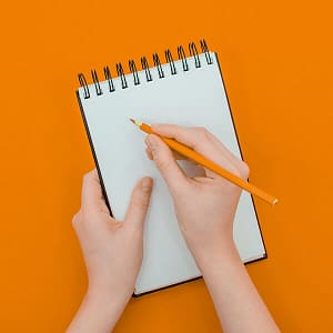 A person writing something in a notepad