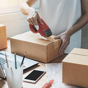 A person packing up an order from an ecommerce website