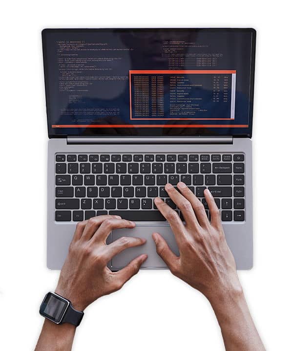 A developer typing code on a laptop