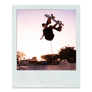 A polaroid photo of a boy skateboarding